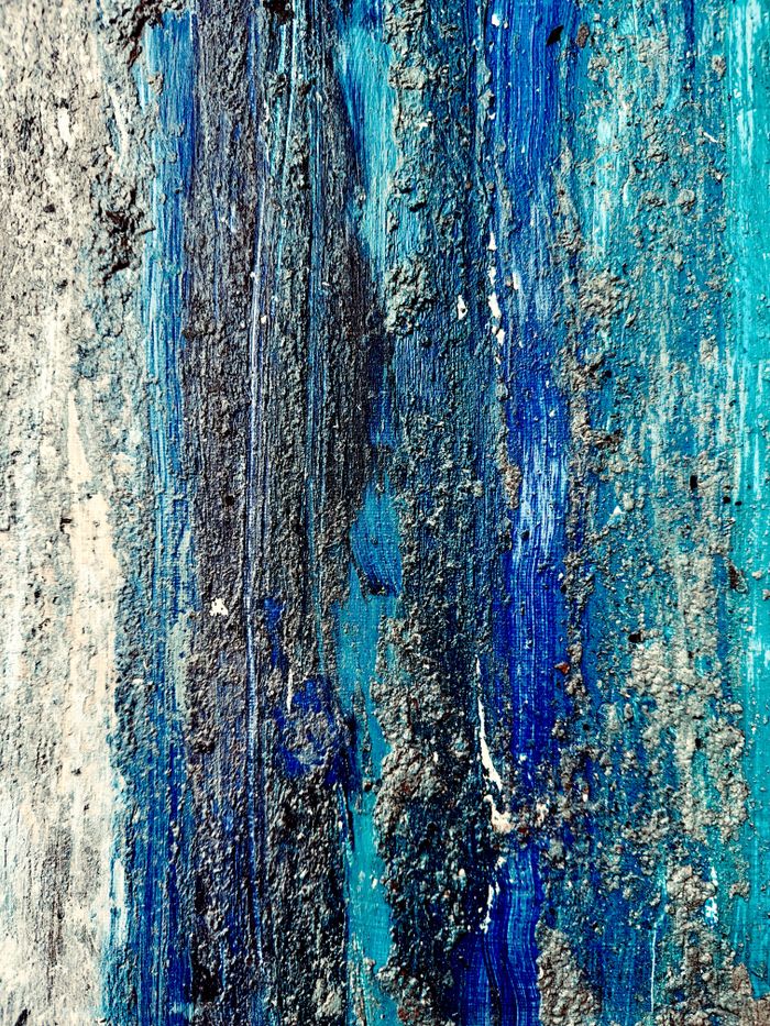 Offerings Close-up of rough, textured blue surface resembling a natural abstract painting.